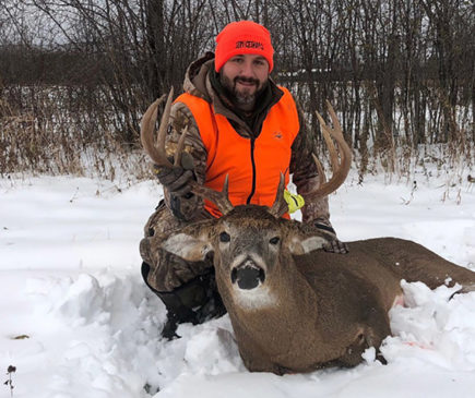 hunter posing with buck