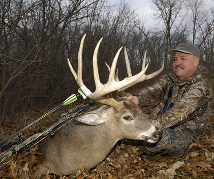 man posing with buck