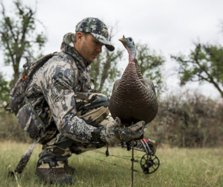 A man dressed in camouflage out turkey hunting in Montana.