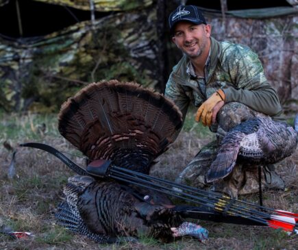 Hunter with Turkey and Broadheads